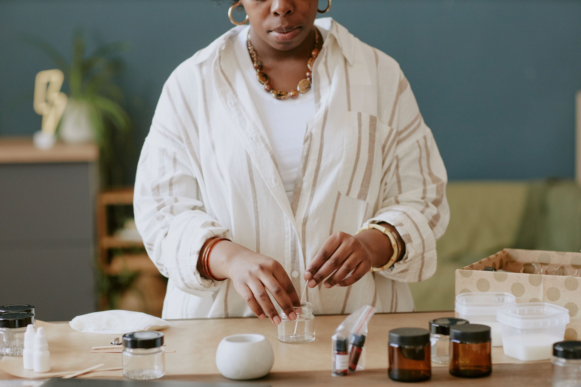 Preparing Essential Oils at Wooden Table in Cozy Room
